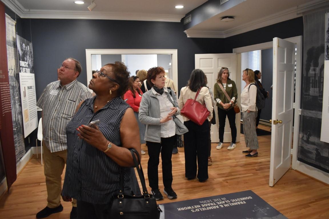 Group looks around at museum facts
